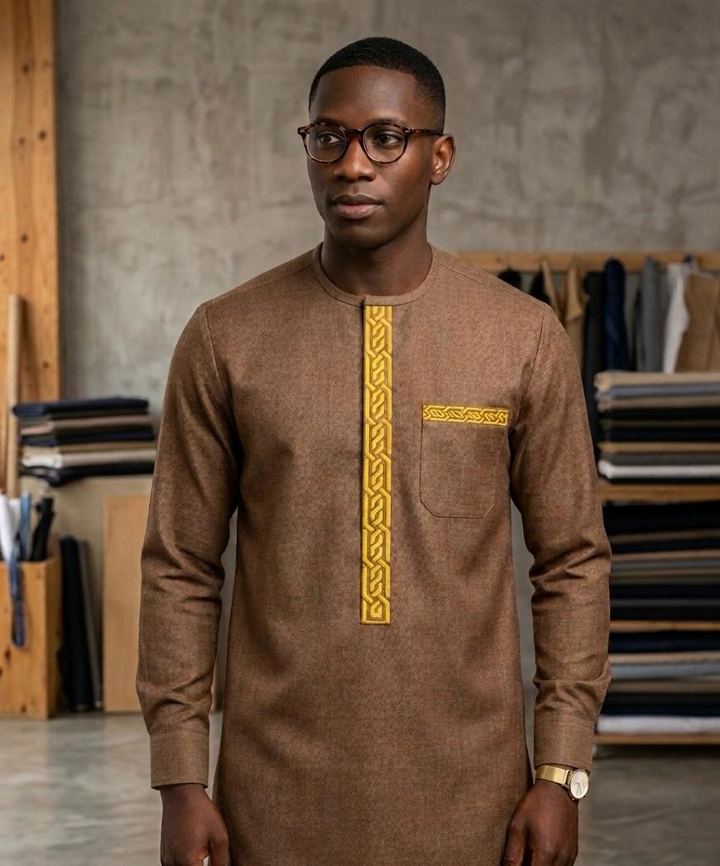 Man in a brown two-piece set with gold embroidery down the chest