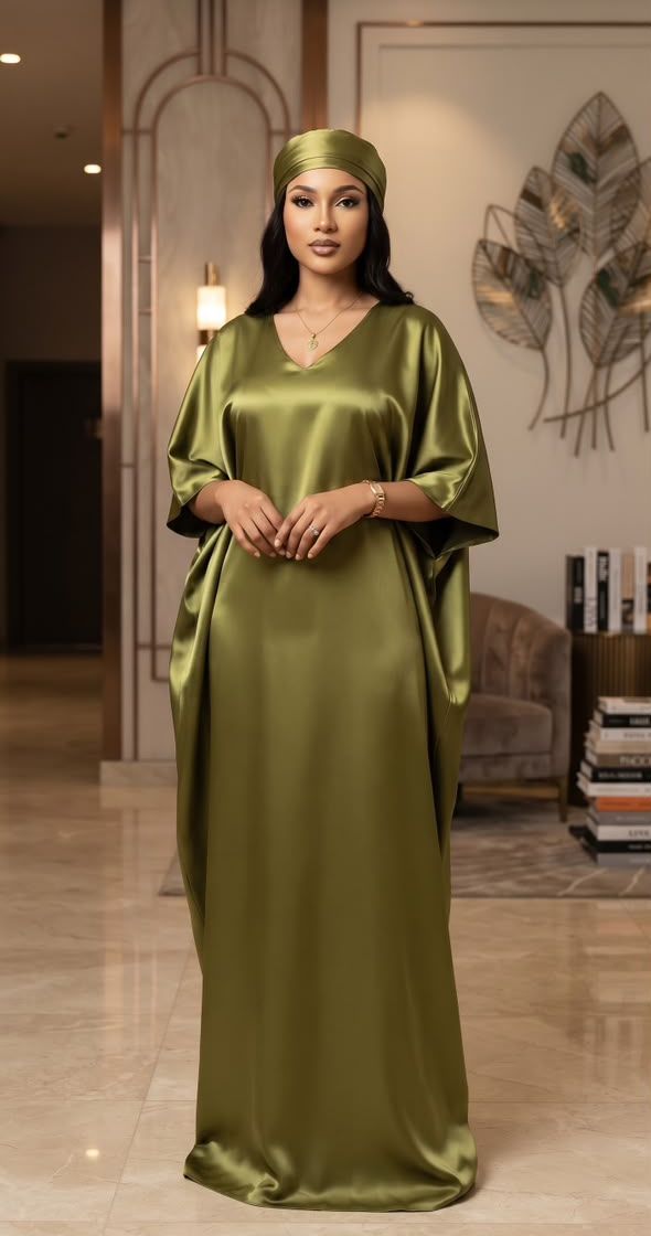 Woman in an olive green silk kaftan dress with matching head wrap