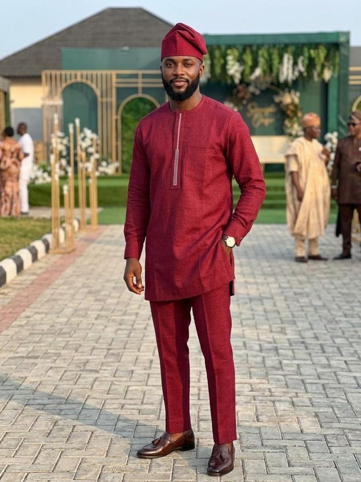 Man in a maroon two-piece kaftan set with matching cap and brown loafers