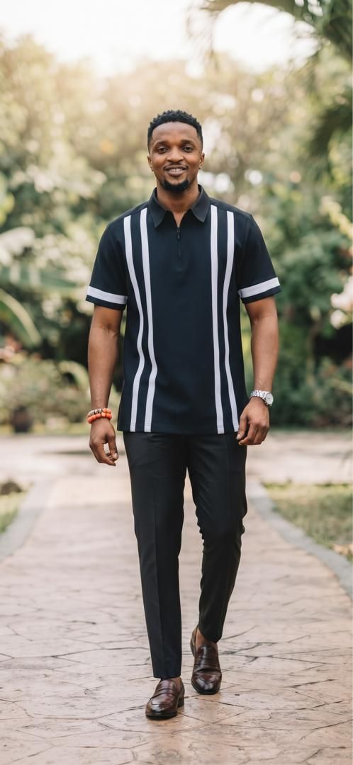 Man in a black short-sleeve top with white stripes and black trousers